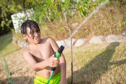 children watering plants in a butterfly garden